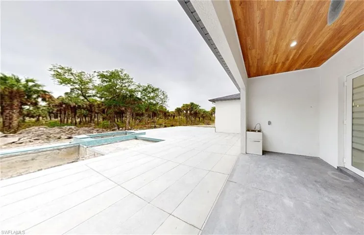 View of patio / terrace featuring a pool with connected hot tub
