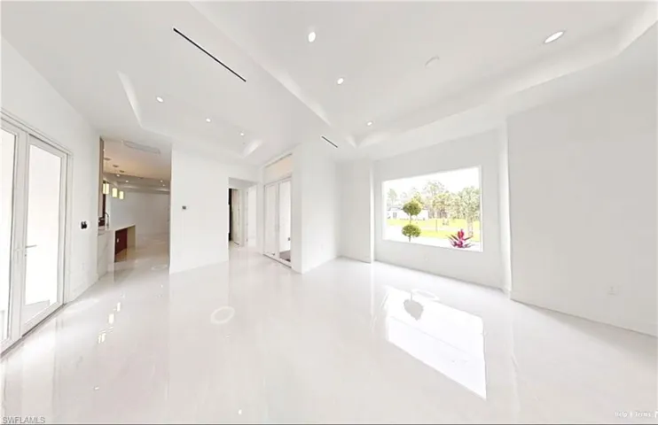 Empty room featuring a raised ceiling and recessed lighting