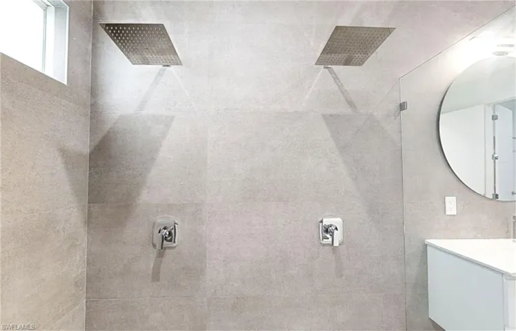 Full bath with a tile shower and vanity
