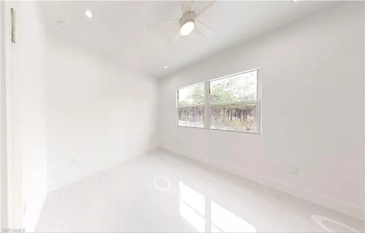 Empty room featuring ceiling fan, baseboards, and recessed lighting