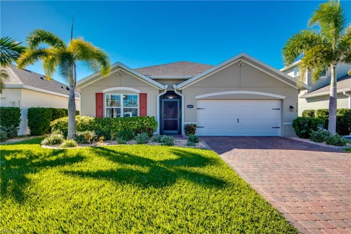 Single story home featuring a garage and a front yard