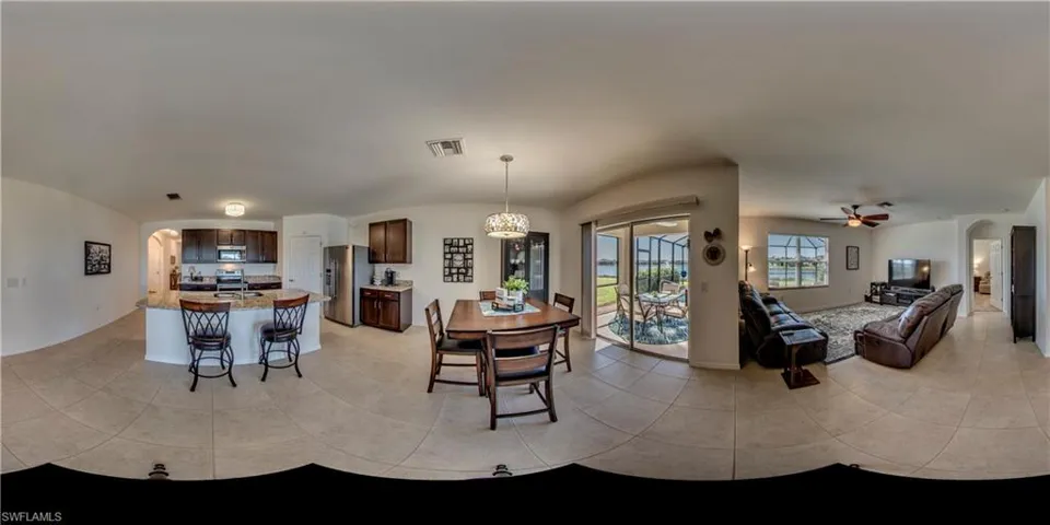 Living room featuring ceiling fan and light tile flooring