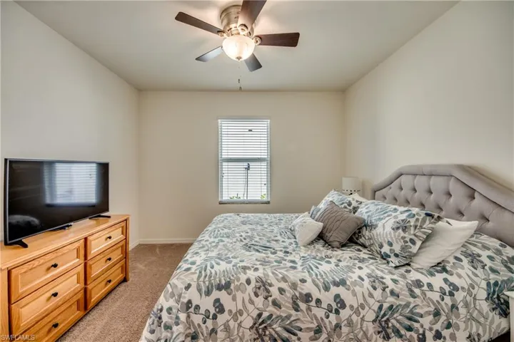 Carpeted bedroom with ceiling fan