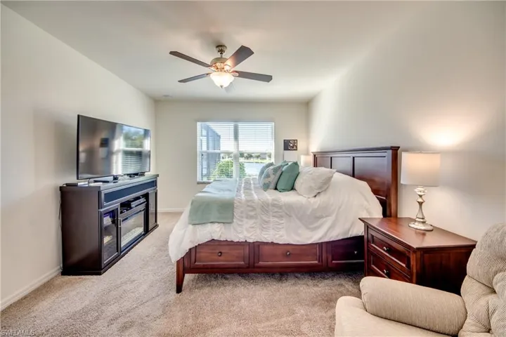 Carpeted bedroom with ceiling fan
