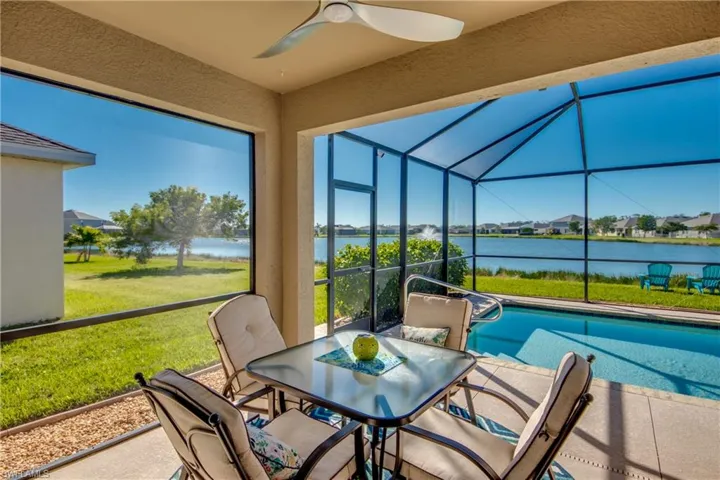 Sunroom / solarium with a water view and ceiling fan