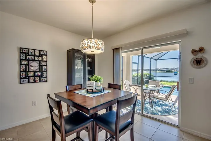 Tiled dining space featuring a water view