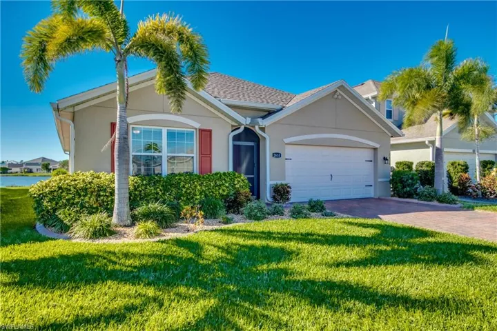 View of front of home with a garage and a front yard