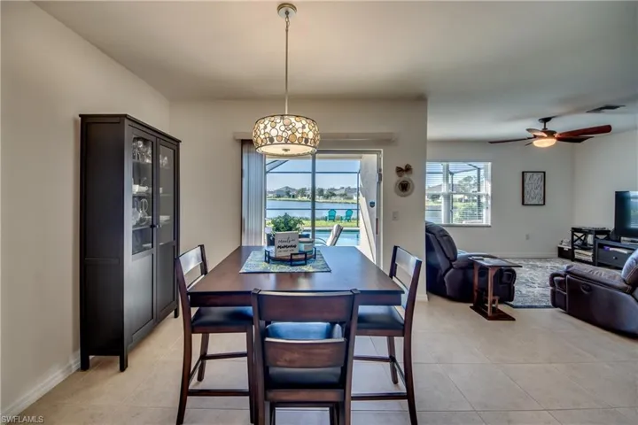 Tiled dining space featuring ceiling fan
