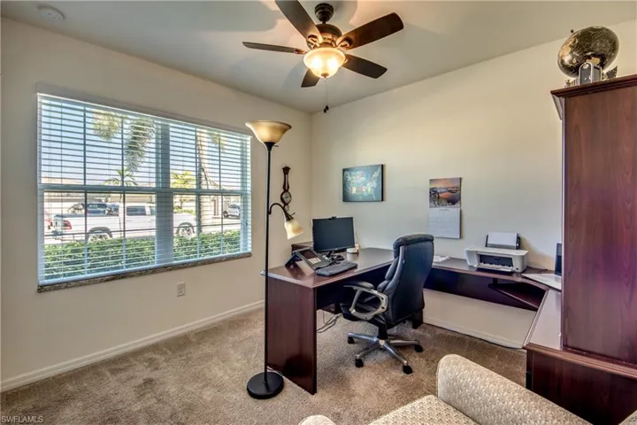 Office area featuring carpet flooring and ceiling fan