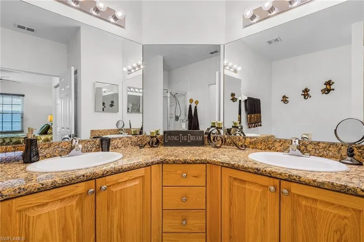 Bathroom with double vanity and a shower stall