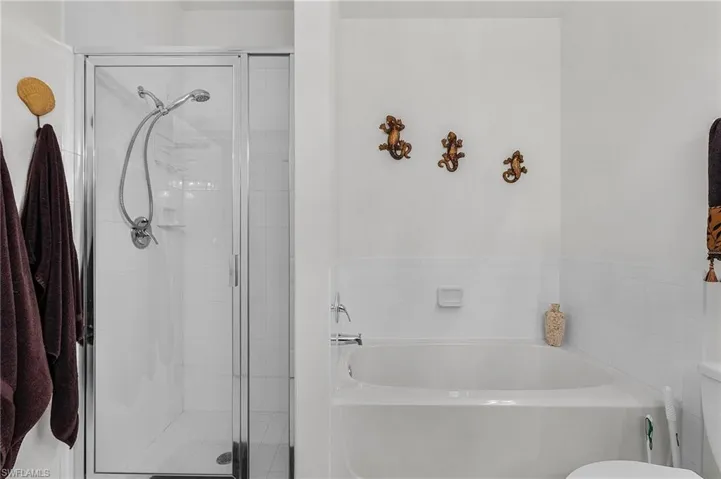 Bathroom with a garden tub and a stall shower