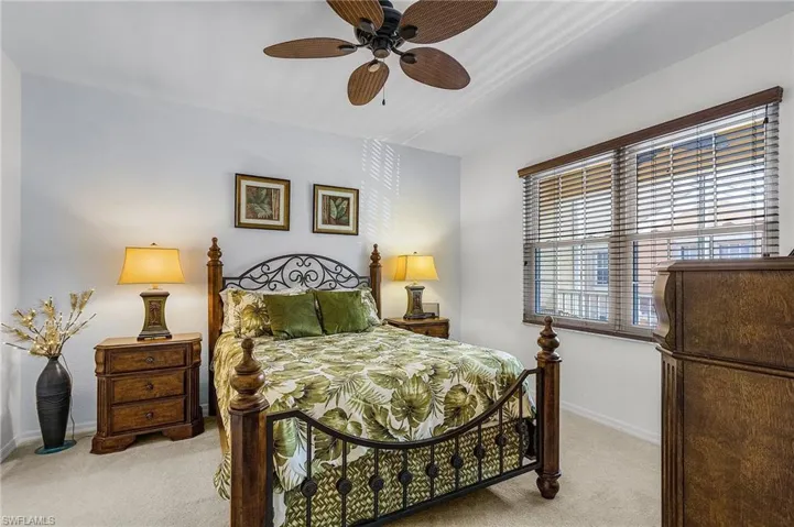 Bedroom featuring light colored carpet and a ceiling fan