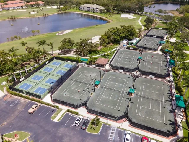 Aerial view of the Tennis & Pickleball courts located next to the Clubhouse. Surrounding area featuring lakes and views of the golf course.