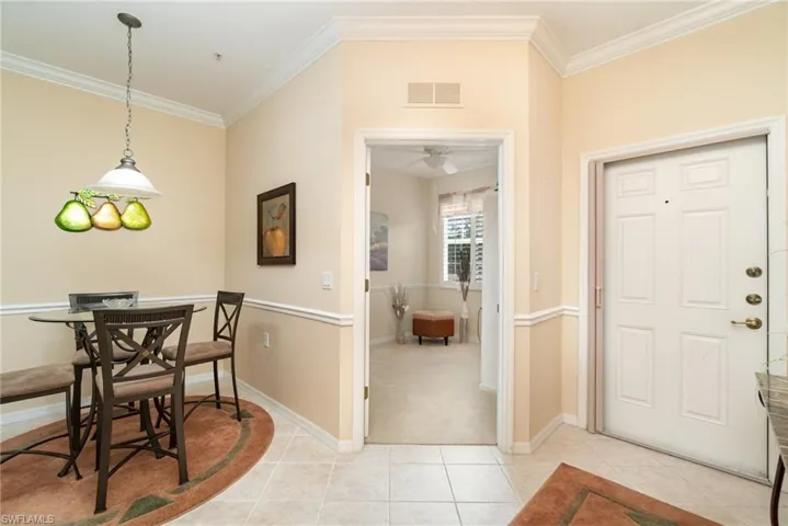 Inside entry with hallway, entry to the den and dinette.