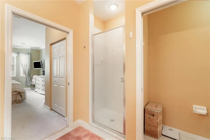 Primary bathroom looking into the bedroom with 2  walk -in closets.