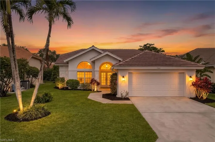 Front of house at sunset with 2 car garage