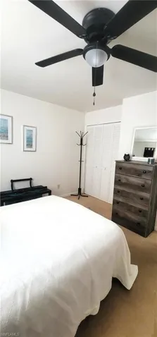 Carpeted bedroom 2 with a closet