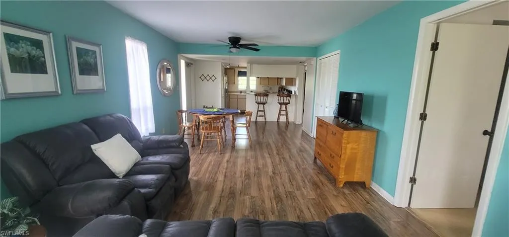 Living room featuring wood finished floors and a ceiling fan