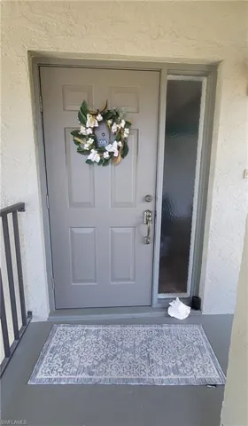 View of exterior entry with stucco siding