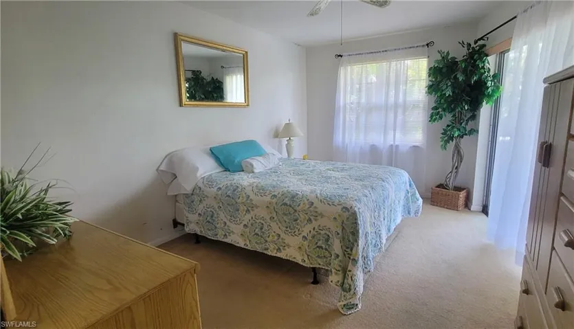 Carpeted bedroom featuring baseboards