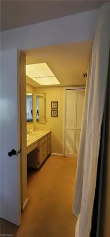 Bathroom featuring vanity with walk in shower