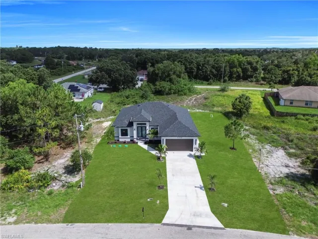 View from above of property featuring a heavily wooded area