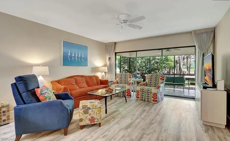 Living area featuring light wood finished floors and a ceiling fan