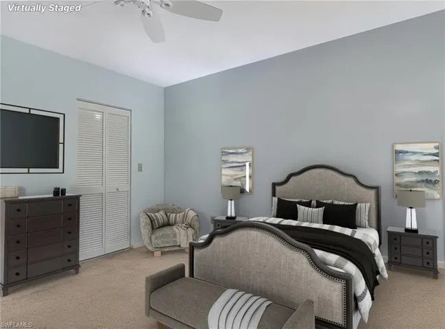 Carpeted bedroom featuring a closet and a ceiling fan
