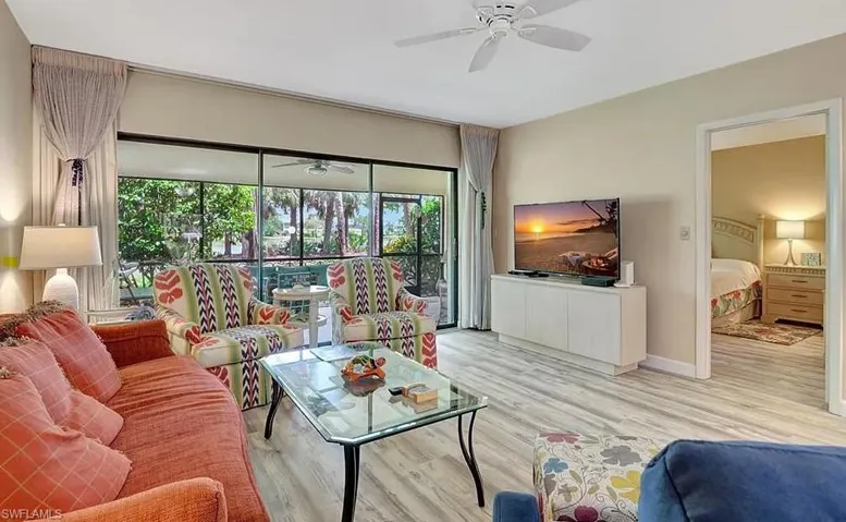 Living room with ceiling fan and wood finished floors