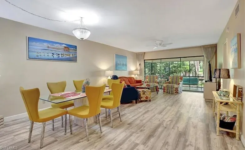 Dining space with light wood-style flooring and ceiling fan