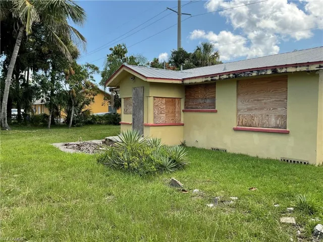 View of home's exterior with a lawn and stucco siding