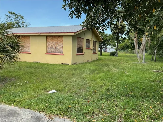 View of property exterior featuring crawl space, stucco siding, and a metal roof