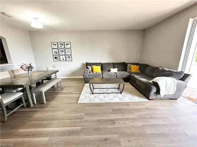 Living area featuring light wood-type flooring and baseboards