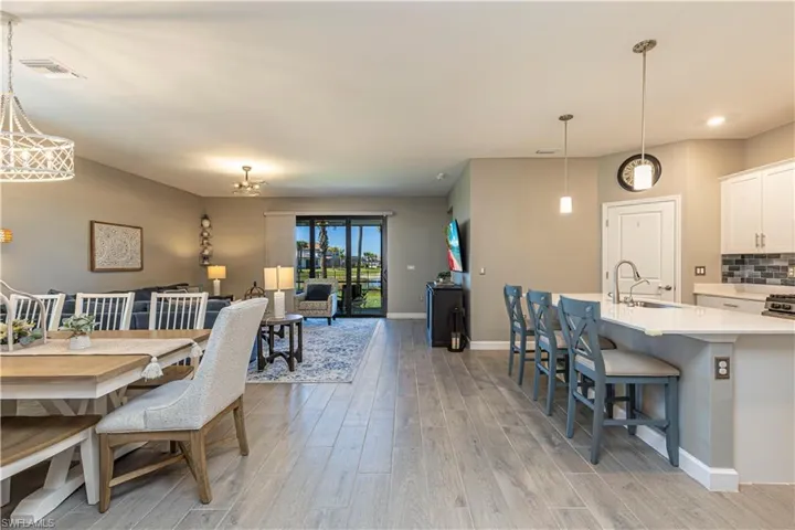 Dining area featuring baseboards, visible vents, and light wood-type flooring