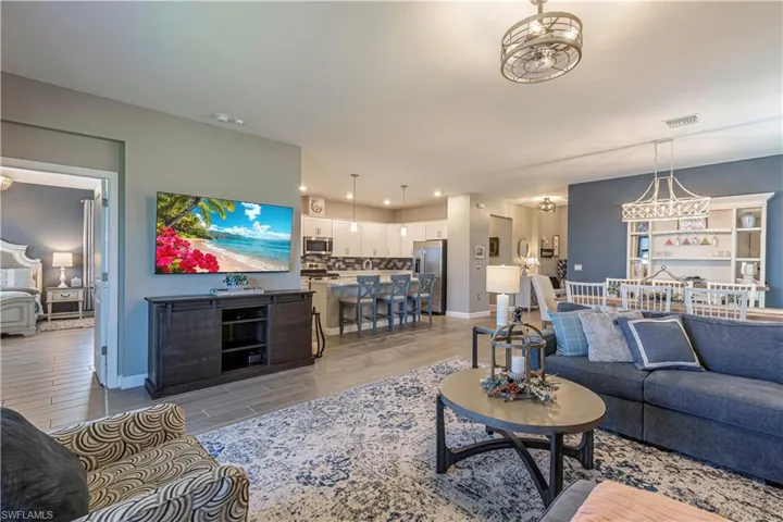 Living area with visible vents, recessed lighting, baseboards, and light wood-style floors