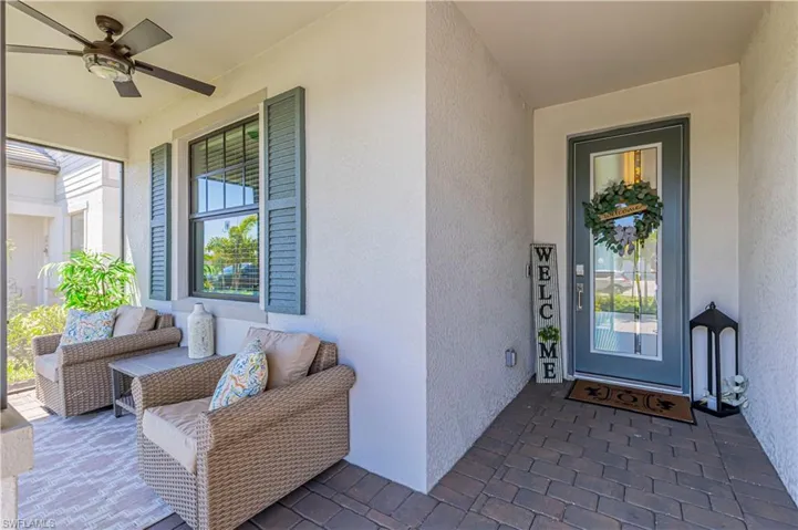View of exterior entry featuring ceiling fan and stucco siding