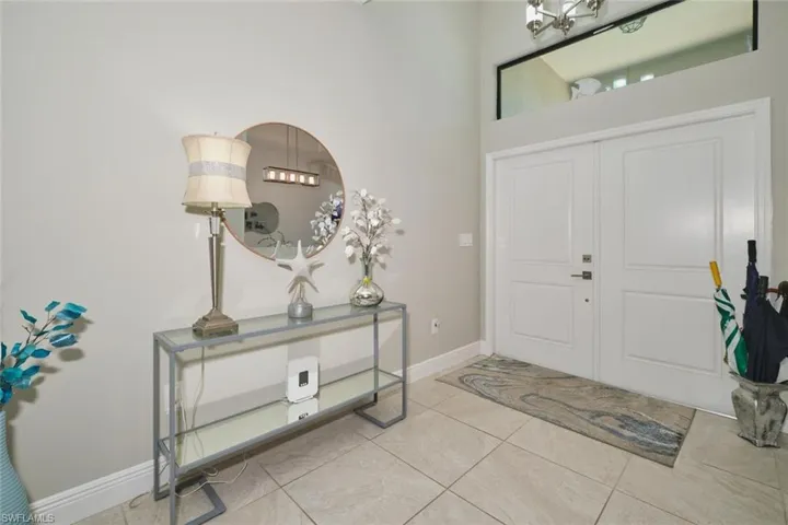 Entryway featuring a double door entry, transom window, and tile flooring