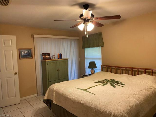 Guest bedroom with slider onto lanai.