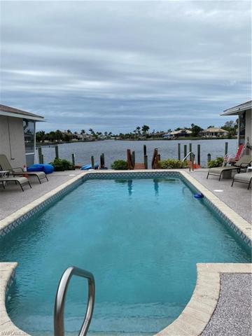 Looking out the courtyard towards the dock's and Lake Louise beyond. The pool screen enclosure is scheduled for replacement shortly. There are 2 units on either side of the pool.