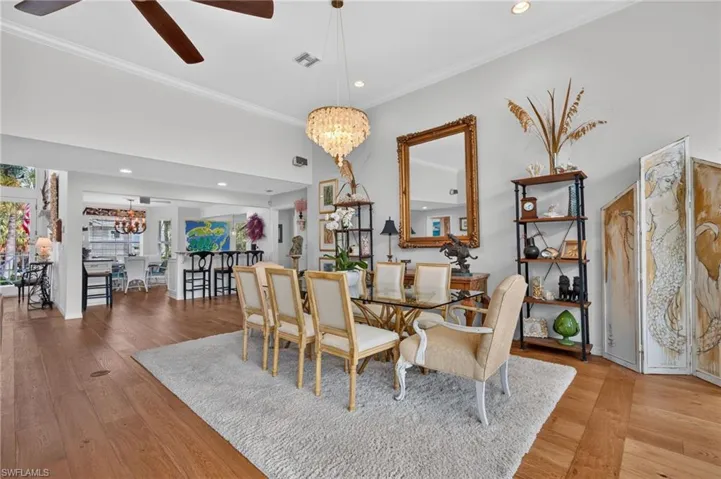 Wood-finish flooring throughout, a vaulted ceiling, and recessed lighting