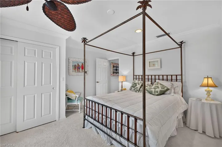 Recessed ceiling lighting, crown molding, and a ceiling fan with woven blades