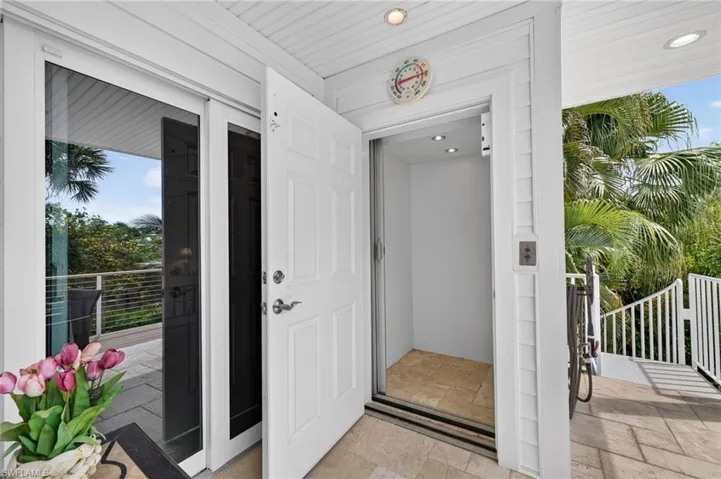 Integrated residential elevator with recessed lighting, shiplap ceiling, and tile flooring