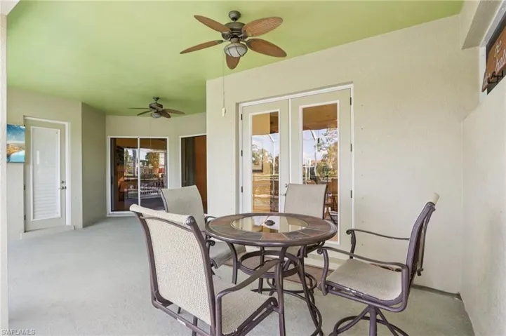 Sunroom featuring outdoor dining space, a patio area, plenty of natural light, and ceiling fan