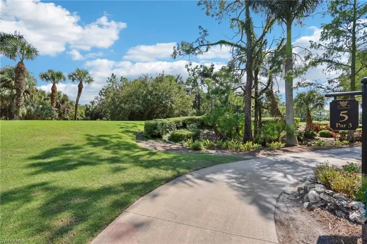 View of property's community with a lawn
