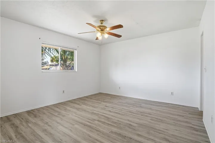 Unfurnished room featuring light wood-style flooring and a ceiling fan