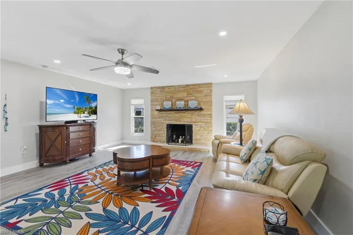 Great room featuring sliding glass doors to pool and a fireplace.
