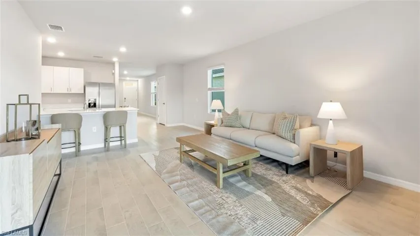 Living room with light hardwood / wood-style floors