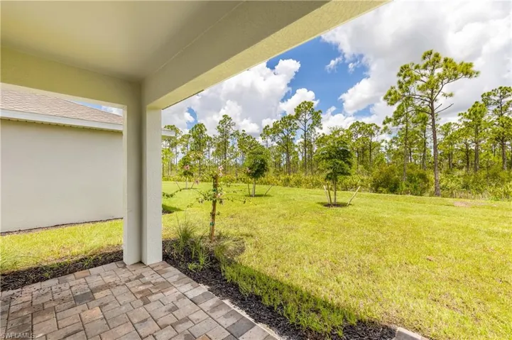 View of grassy yard with a patio