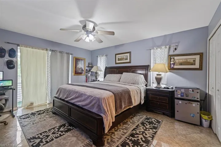 Bedroom featuring light tile patterned flooring and a ceiling fan