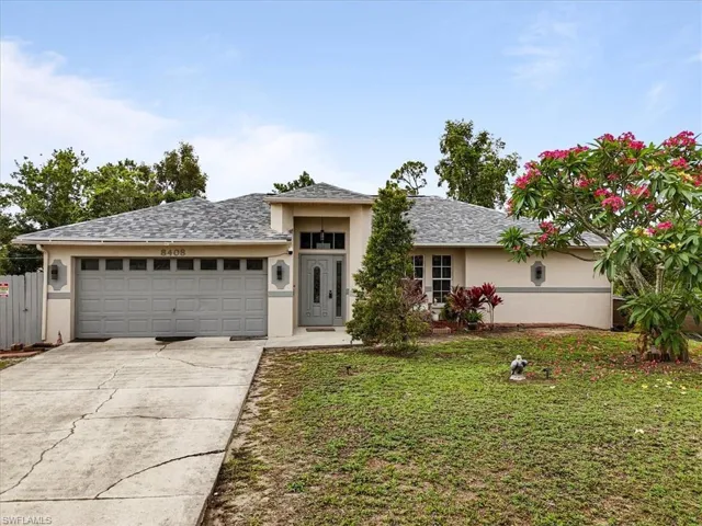 View of front of house featuring stucco siding, a garage, driveway, and a shingled roof